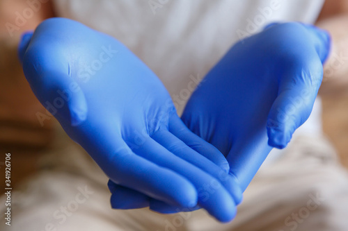Men's hands in medical gloves hold something.