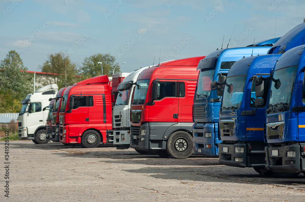 Row of trucks parked on a large parking lot