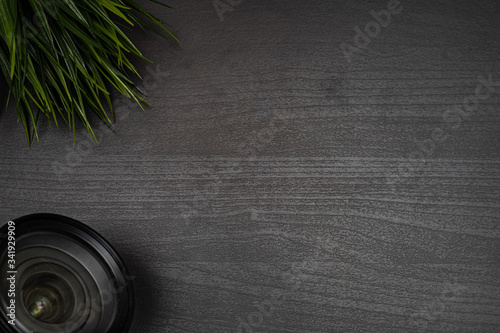 camera lens on dark wooden table