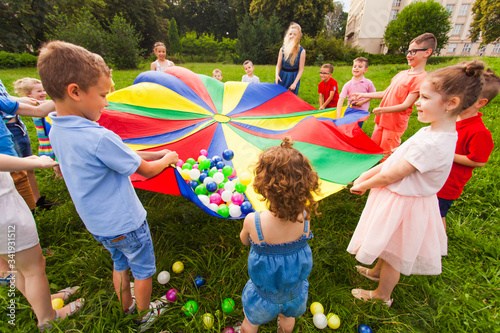 Cheerful children playing outdoors at birthday party