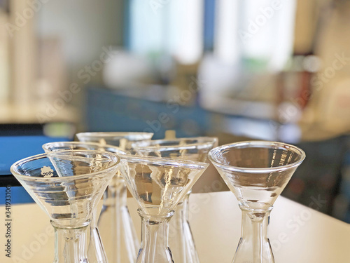 The Erlenmeyer flask with filtrate funnel clear glassware using for filter chemical solid or liquid sample put on science laboratory bench. chemistry or medical room clean and protect contamination.
