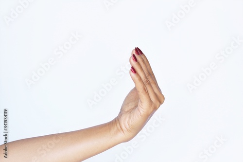 Gesture woman hand red nail polish mean calling or come on. photo isolate on white side view copy space