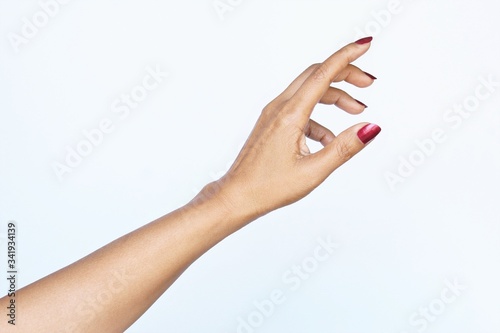 Gesture reaching up woman hand red nail polish Fototapet