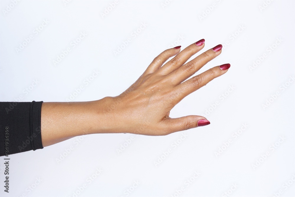 Wet back side of woman hand red nail polish wearing black long sleeve t-shirt. photo isolate on white copy space