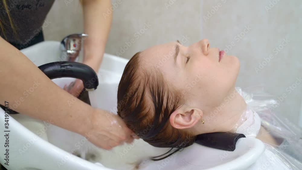staining of the roots of the hair dye. gray shading. hands in black gloves. staining of the roots of the hair dye. gray shading. hands in black gloves.