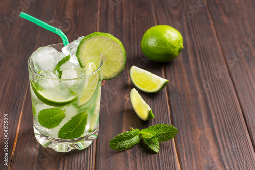 Summer cooling drink with ice, lime and mint. Non-alcoholic beverage.
