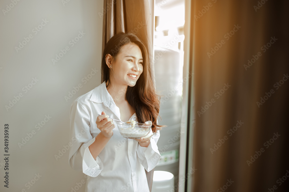 Young woman asia wake up refreshed in the morning and relaxing eat coffee, cornflakes, bread and apple for breakfast at house on holiday. Asian, asia, relax, breakfast, refresh, lifestyle concept. Young woman asia wake up refreshed in the morning and relaxing eat coffee, cornflakes, bread and apple for breakfast at house on holiday. Asian, asia, relax, breakfast, refresh, lifestyle concept.