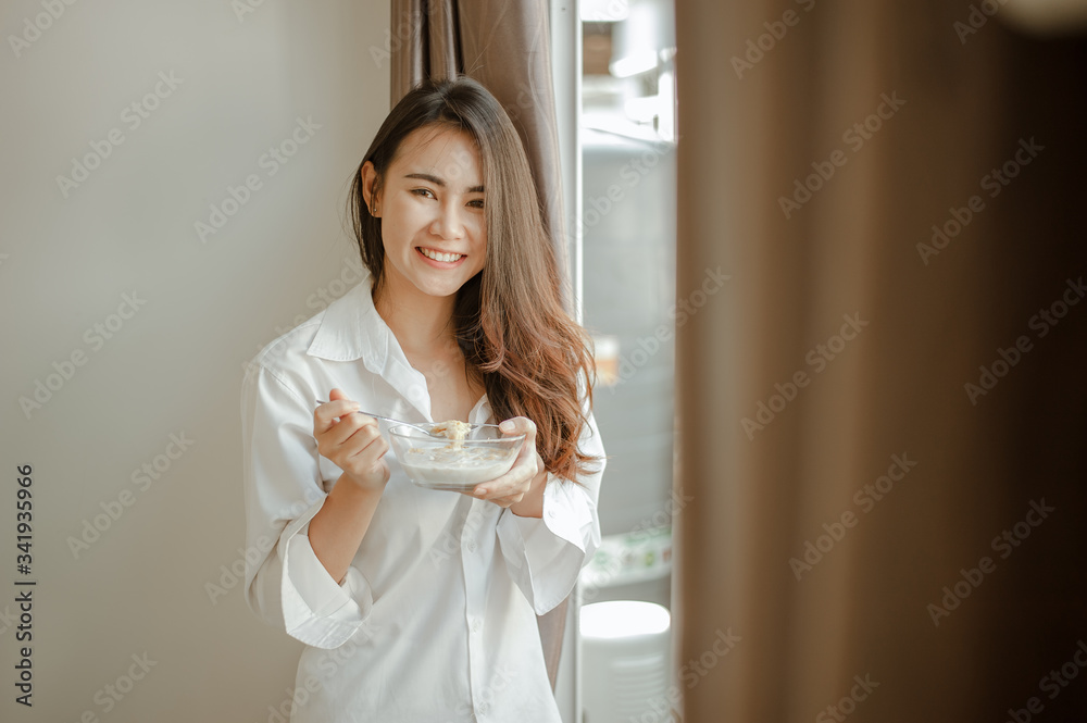 Young woman asia wake up refreshed in the morning and relaxing eat coffee, cornflakes, bread and apple for breakfast at house on holiday. Asian, asia, relax, breakfast, refresh, lifestyle concept. Young woman asia wake up refreshed in the morning and relaxing eat coffee, cornflakes, bread and apple for breakfast at house on holiday. Asian, asia, relax, breakfast, refresh, lifestyle concept.