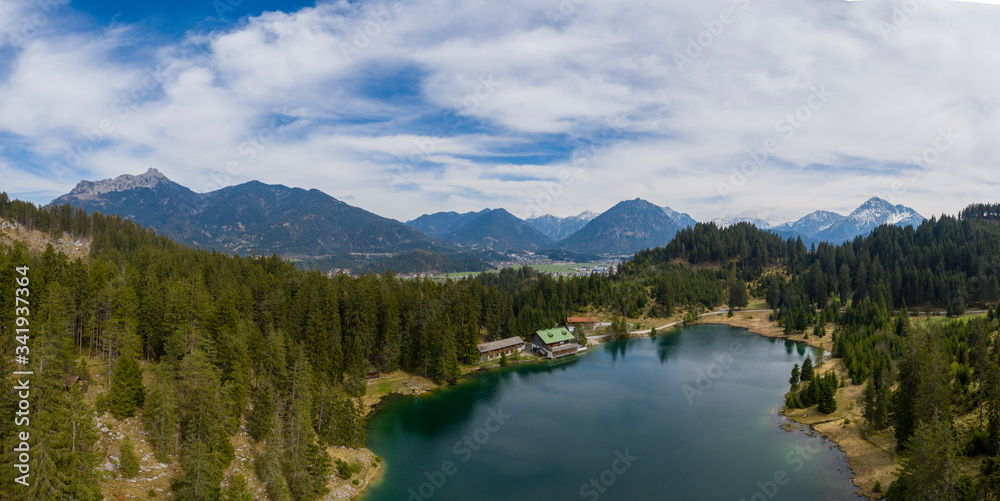 Aerial panorama view over lake Frauensee at Tirol alps mountains in spring