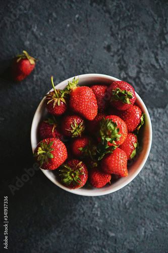 red ripe strawberries in a plate on the table