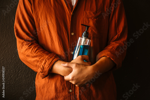 Man hands holding alcohol sanitizer gel for protecting infection from a corona virus and other viruses. photo