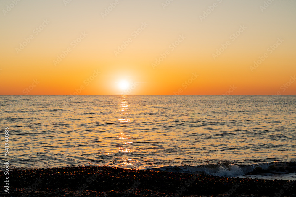 the sun sets on the horizon in the Black Sea in Sochi at sunset