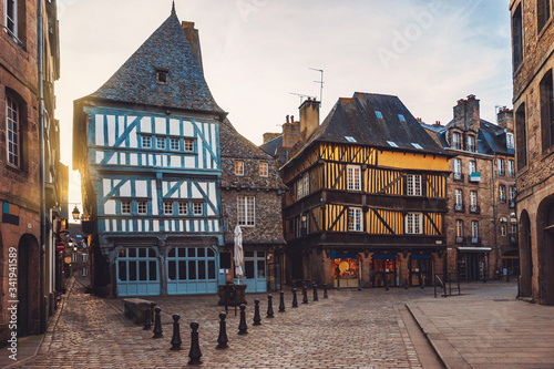 Fototapeta Naklejka Na Ścianę i Meble -  Beautiful street of the medieval French city of Dinan with ancient half-timbered houses. Popular tourist city of France. Dinan is a walled Breton town and  tourist attraction in Brittany, France.