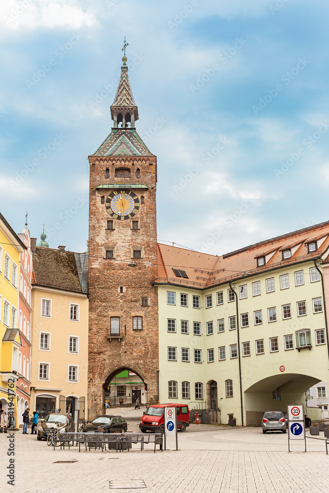 a small town square and an old watchtower at the entrance to the ancient German city of Landsberg am Lech