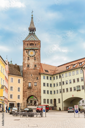 a small town square and an old watchtower at the entrance to the ancient German city of Landsberg am Lech