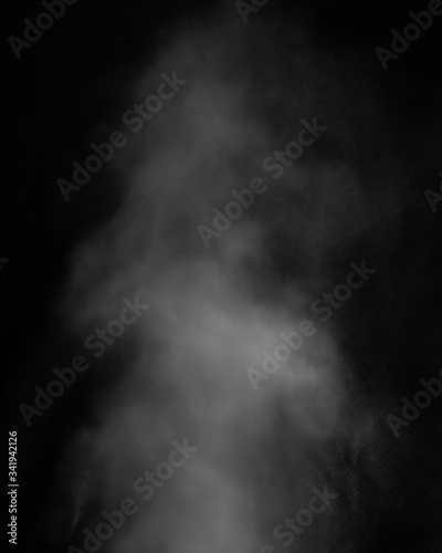 White clouds of smoke vapor isolated on a black background. The magic effect of foggy dust, which can be used when applying and changing their transparency