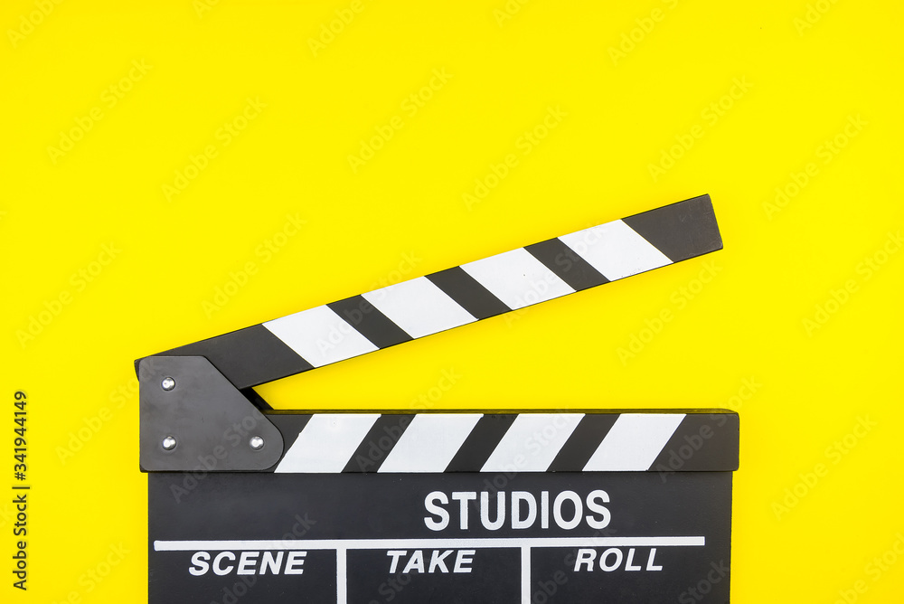 Naklejka premium Movie clapper isolated on yellow background.