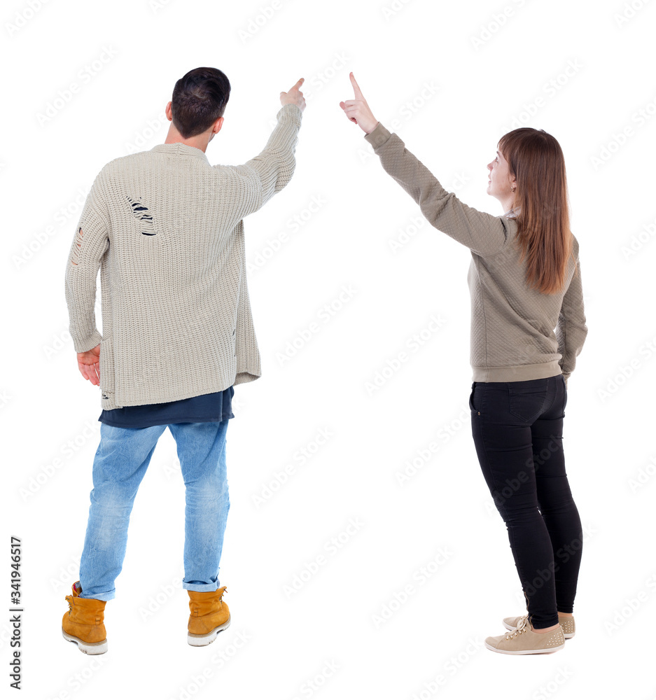 Back view of couple in sweater pointing. Back view of couple in sweater pointing.