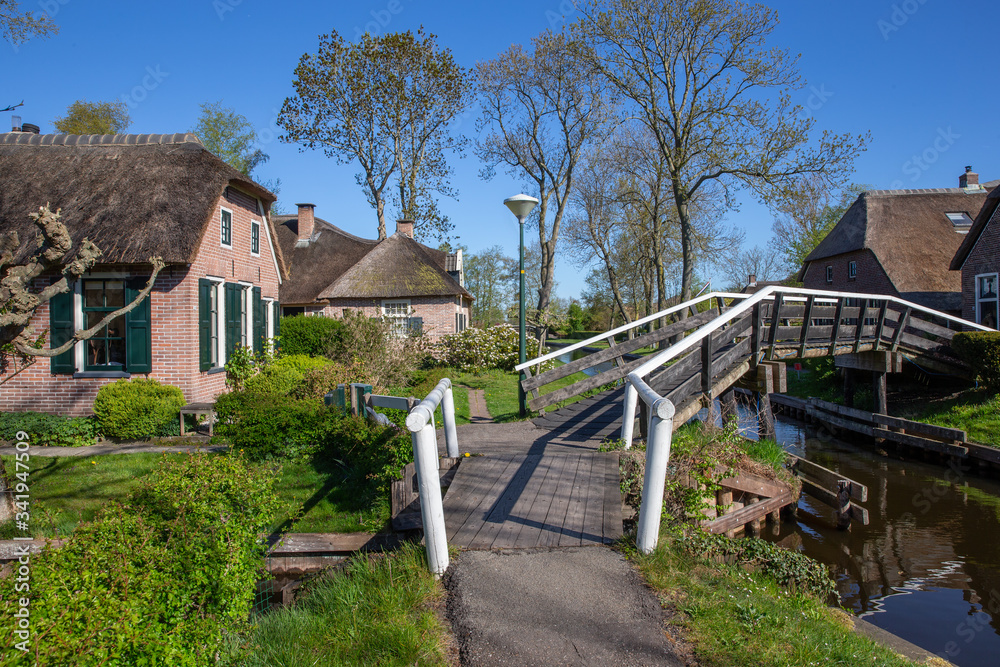 Giethoorn Overijssel Netherlands. During Corona lock-down. Empty streets, paths, bridges and canals. Old farmhouse Giethoorn Overijssel Netherlands. During Corona lock-down. Empty streets, paths, bridges and canals. Old farmhouse