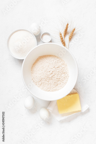 Photo Ingredients for baking on the white textured table
