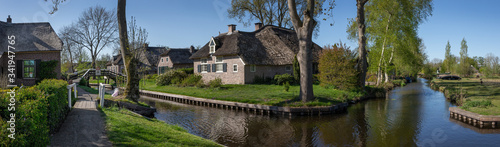 Giethoorn Overijssel Netherlands. During Corona lock-down. Empty streets, paths, bridges and canals. Old farmhouse panorama © A