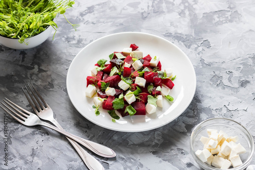 Baked beets with feta cheese and shoots of young peas