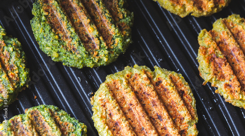 Vegan cutlets. Vegetarian, chickpea cutlets with spinach for a diet burger. .Vegan food. Grilled. Protein product.