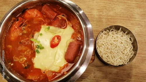 Korean Hot pot spicy Budae Jjigae with sausage, vegetables, pork, prawn, tofu and cheese