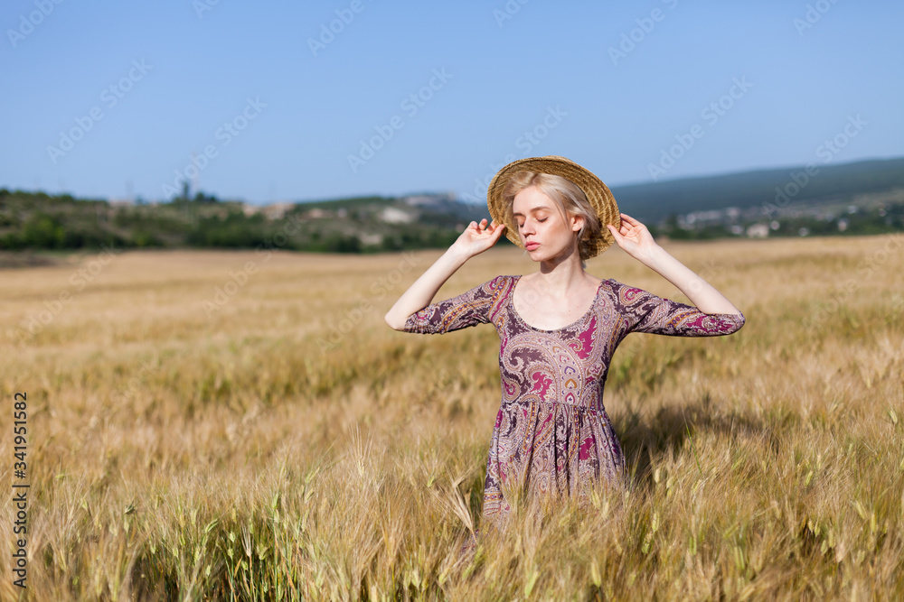 portrait of a beautiful fashionable woman in a field of wheat harvest portrait of a beautiful fashionable woman in a field of wheat harvest