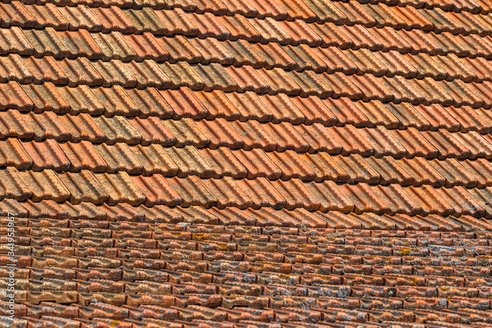 Texture of orange clay roof tiles at different angles. Red old dirty roof. Old roof tiles. Construction equipment build a house. Texture of orange clay roof tiles at different angles. Red old dirty roof. Old roof tiles. Construction equipment build a house.