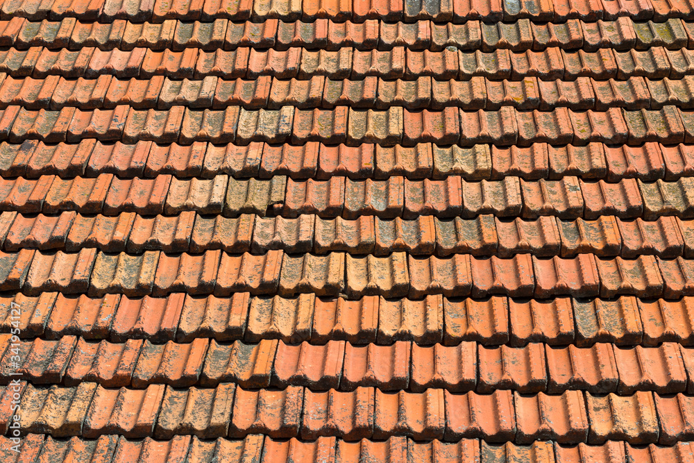 Texture of orange clay roof tiles. Red old dirty roof. Old roof tiles. Construction equipment build a house.