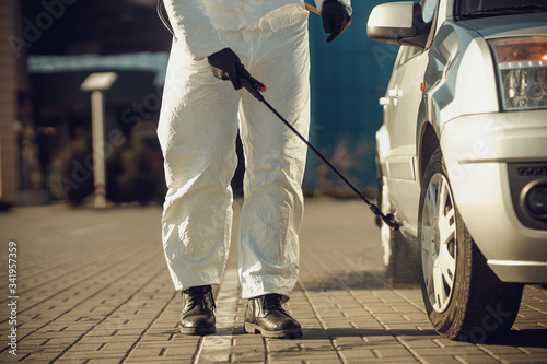 Cleaning and Disinfection of vehicles amid the coronavirus epidemic Car cleaning and disinfection Infection prevention and control of epidemic Protective suit and mask