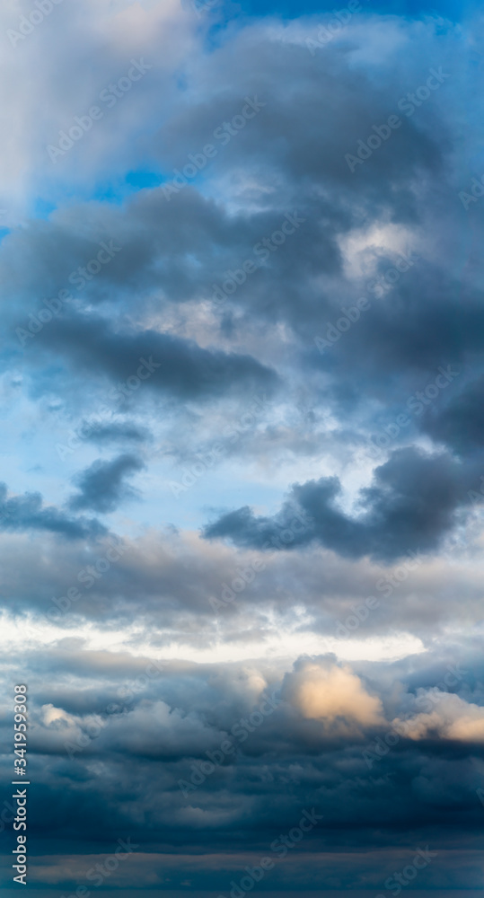 Fantastic clouds at sunrise, vertical panorama