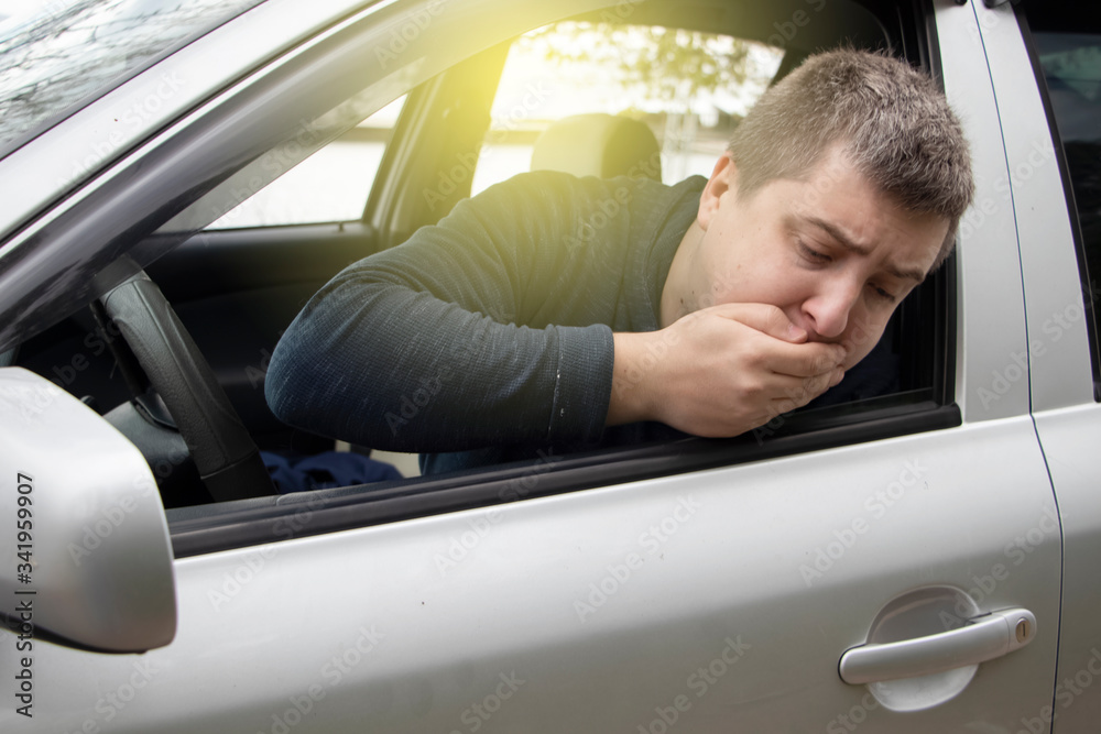 A ride during a car trip. The driver suffers from kinetosis, motion sickness. The concept of motion sickness in transport and vestibular apparatus disease A ride during a car trip. The driver suffers from kinetosis, motion sickness. The concept of motion sickness in transport and vestibular apparatus disease