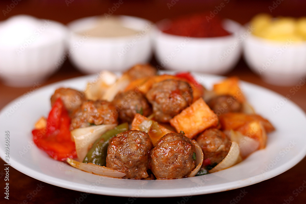 very nice meatball barbecue on white plate with fragrant turkish spices on wooden table
