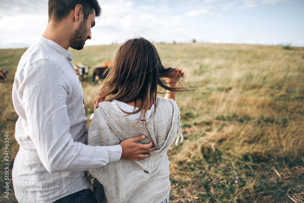 The guy hugs the girl. Rear view The guy hugs the girl. Rear view