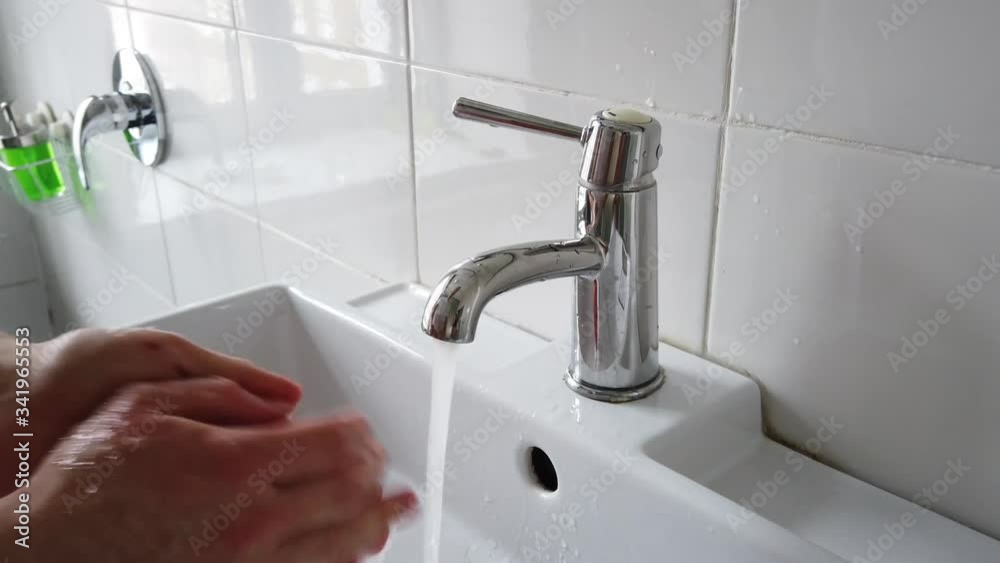Closeup of coronavirus prevention wash hands with soap and water in hospital Closeup of coronavirus prevention wash hands with soap and water in hospital