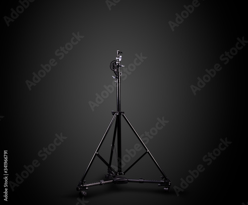 Photo studio lighting stands isolated on the black background.