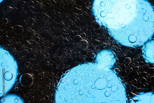 black abstract background with bubbles and blue light spots