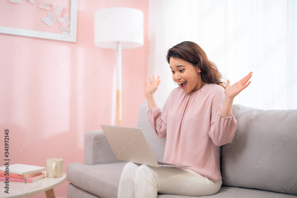 Excited young asian woman lifestyle image using laptop computer Excited young asian woman lifestyle image using laptop computer