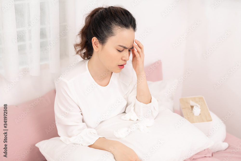 Image of ill woman with headache resting in bed Image of ill woman with headache resting in bed