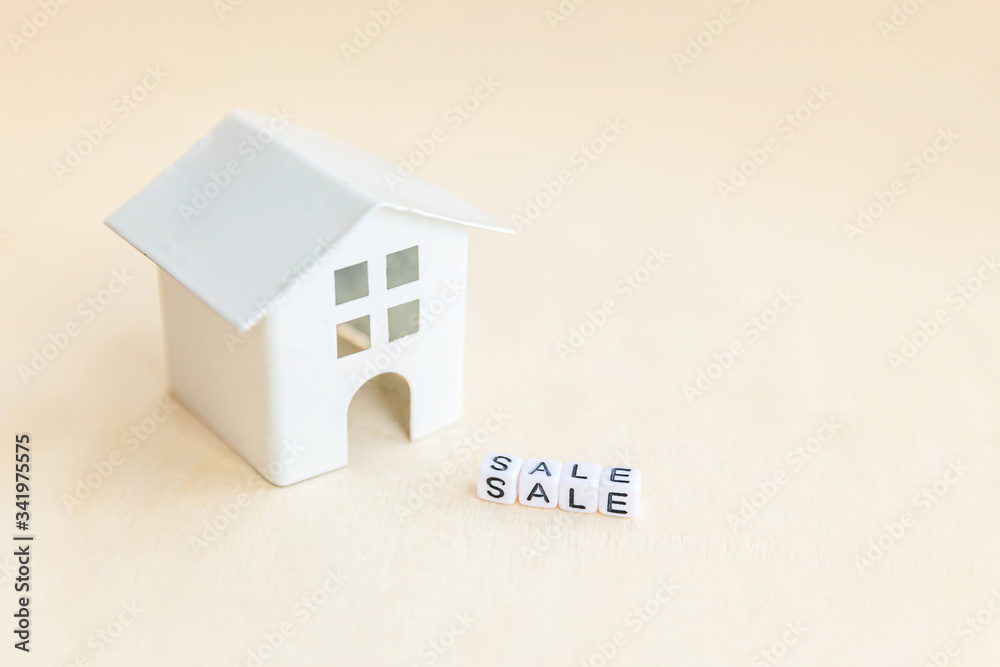 Miniature toy model house with inscription SALE letters word on wooden backdrop. Eco Village, abstract environmental background. Real estate mortgage property insurance sweet home ecology rent concept Miniature toy model house with inscription SALE letters word on wooden backdrop. Eco Village, abstract environmental background. Real estate mortgage property insurance sweet home ecology rent concept