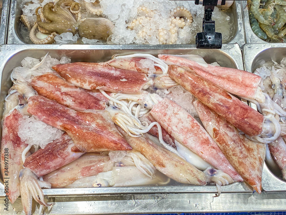 Heap of squids and octopus for sale at seafood store