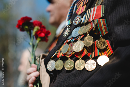 Victory Day. Orders and medals on the chest of a veteran. Close-up.