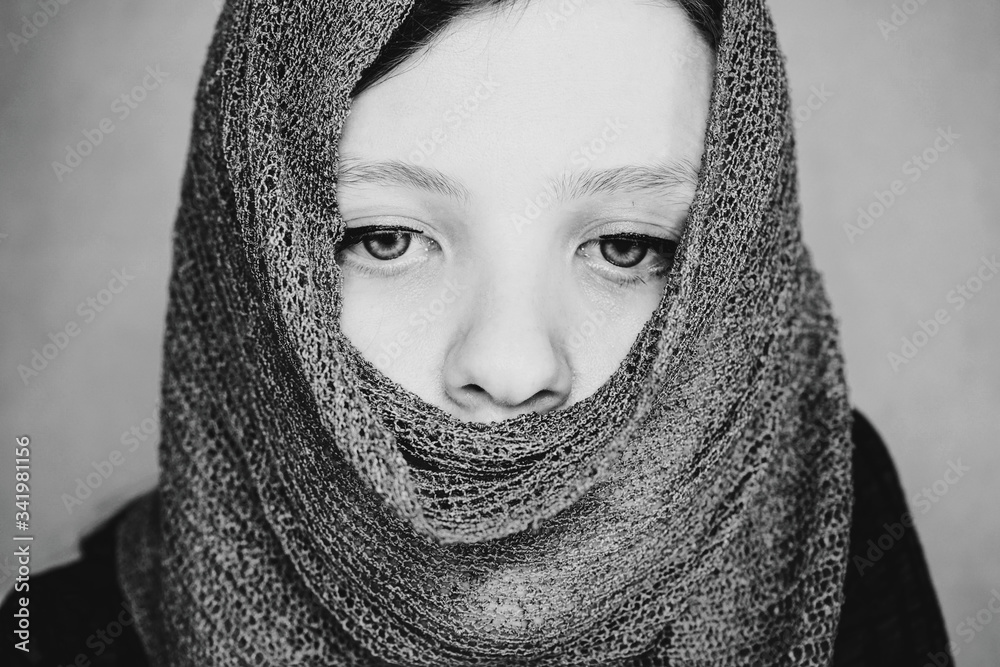 Young woman with beautiful eyes covering her face