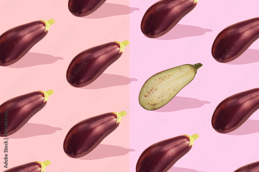 Fototapeta premium Flat lay colorful pattern with eggplant on pastel pink background. Trendy mockup or wallpaper. Minimal healhty lyfestyle concept with sharp shadows.