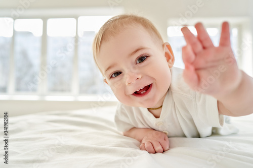 Wow. The baby lying on his tummy laughs and holds out his hand to you. everything is fine. its ok dont worry.