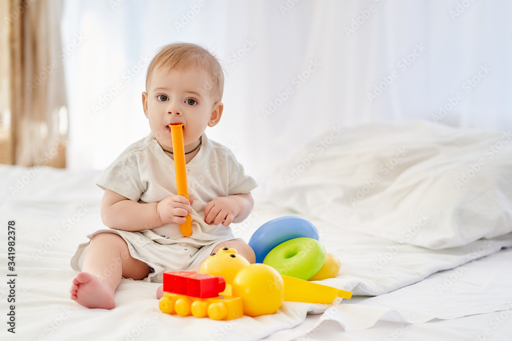 Toddler baby playing with toys, tastes them. Toddler baby playing with toys, tastes them.