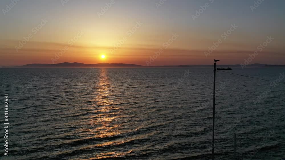 Seascape with a sunset and a ship on the horizon. Seascape with a sunset and a ship on the horizon.