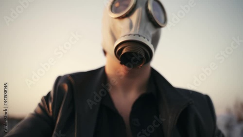 face in gas mask close-up on sky background